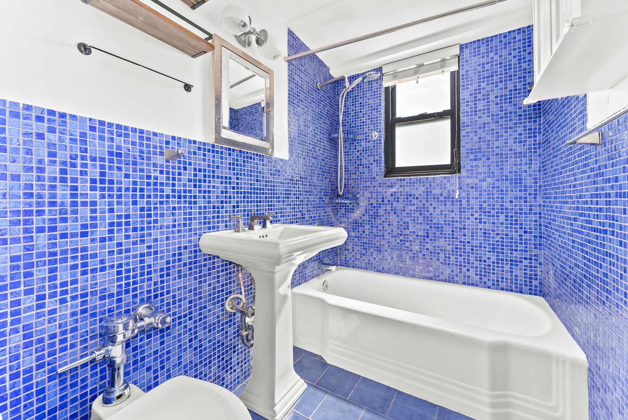 345 West 145th Street, Unit 8C3 Manhattan, NY 10031 - Photo 9 of 12 a bathroom with a sink toilet and shower