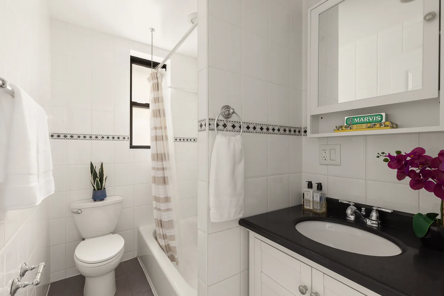 a bathroom with a granite countertop sink toilet a mirror and shower