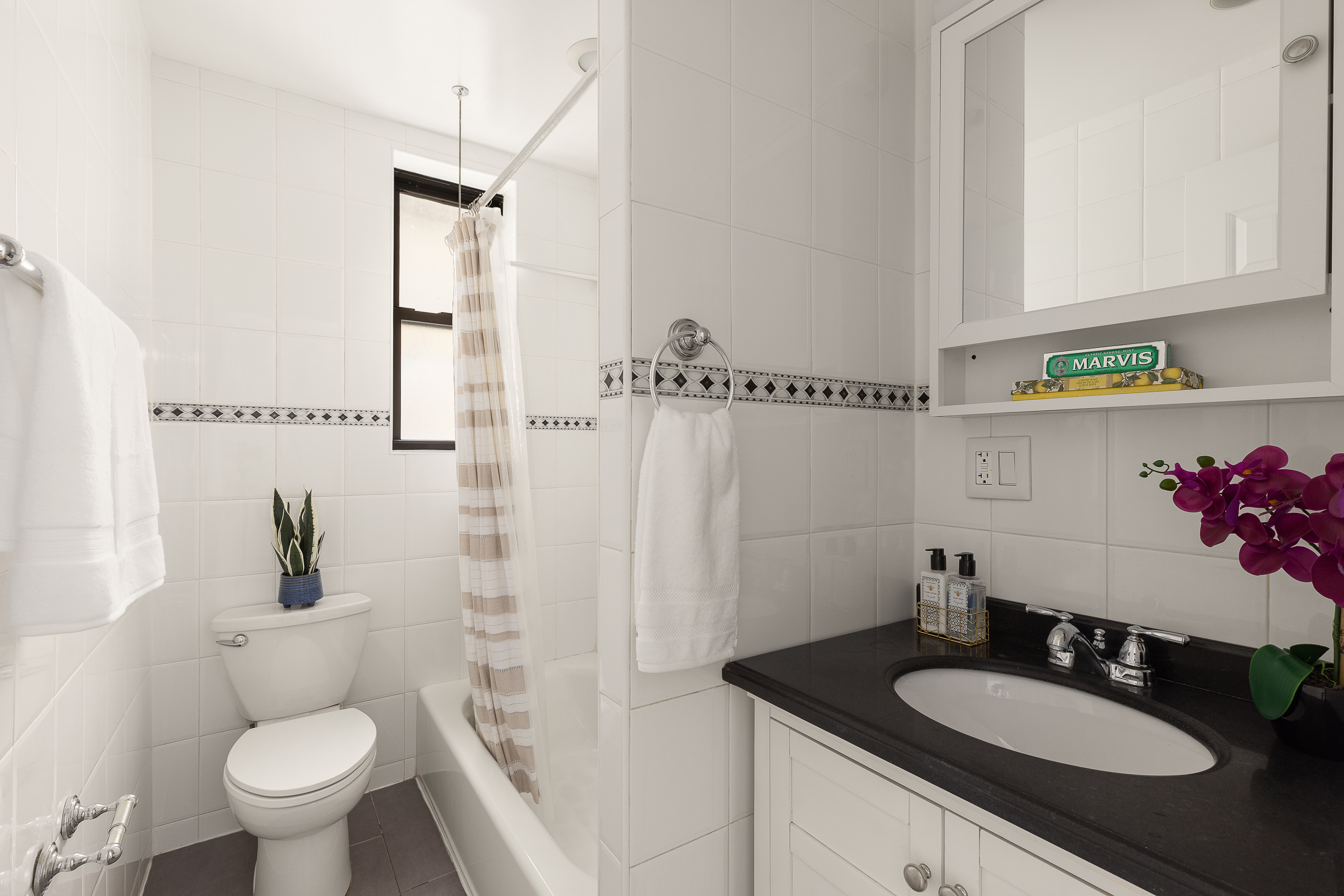 801 Riverside Drive, Unit 4B Manhattan, NY 10032 - Photo 7 of 8 a bathroom with a granite countertop sink toilet a mirror and shower