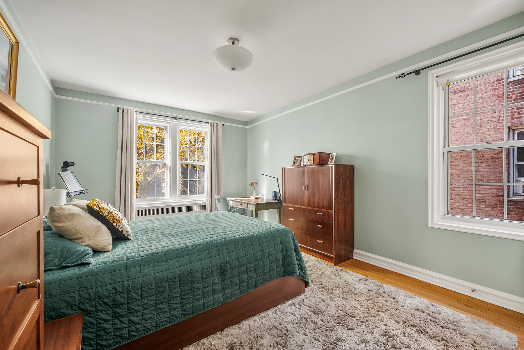 360 Clinton Avenue, Unit 4C Brooklyn, NY 11238 - Photo 6 of 13 a bedroom with a bed and wooden floor