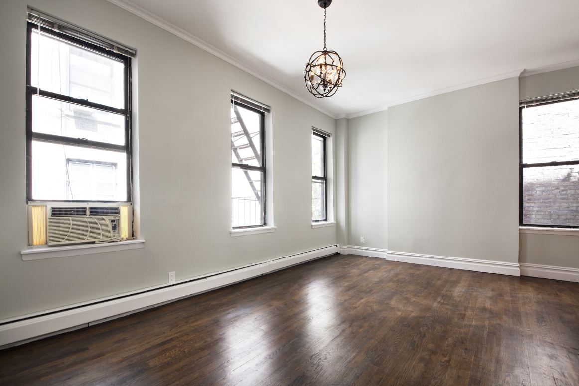 442 Amsterdam Avenue, Unit 4C Manhattan, NY 10024 - Photo 7 of 9 a view of an empty room with wooden floor and a window
