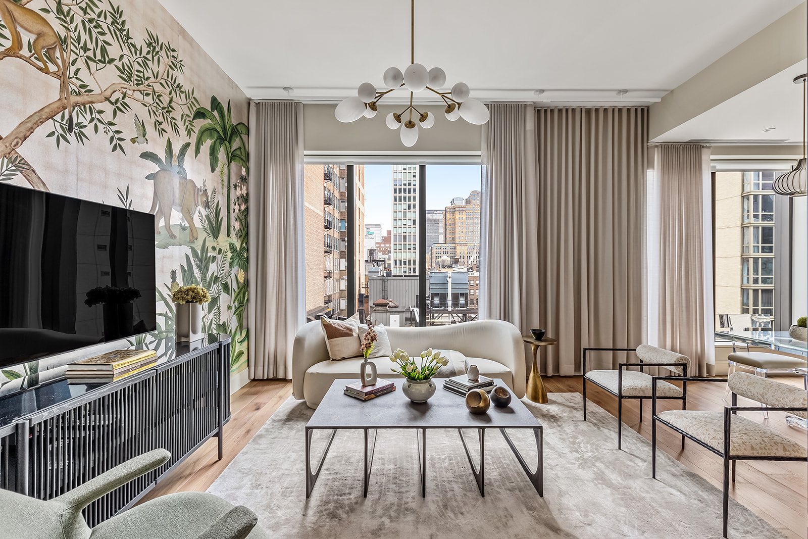 a living room with patio furniture and a flat screen tv