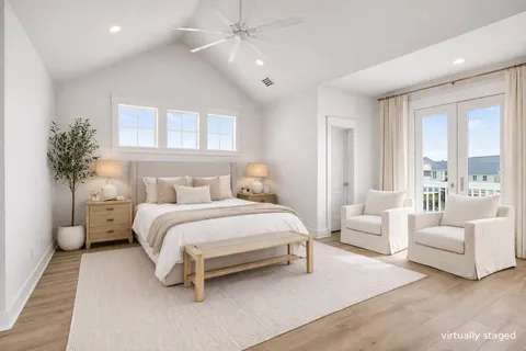 a large white kitchen with kitchen island a stove a sink dishwasher and a refrigerator with wooden floor