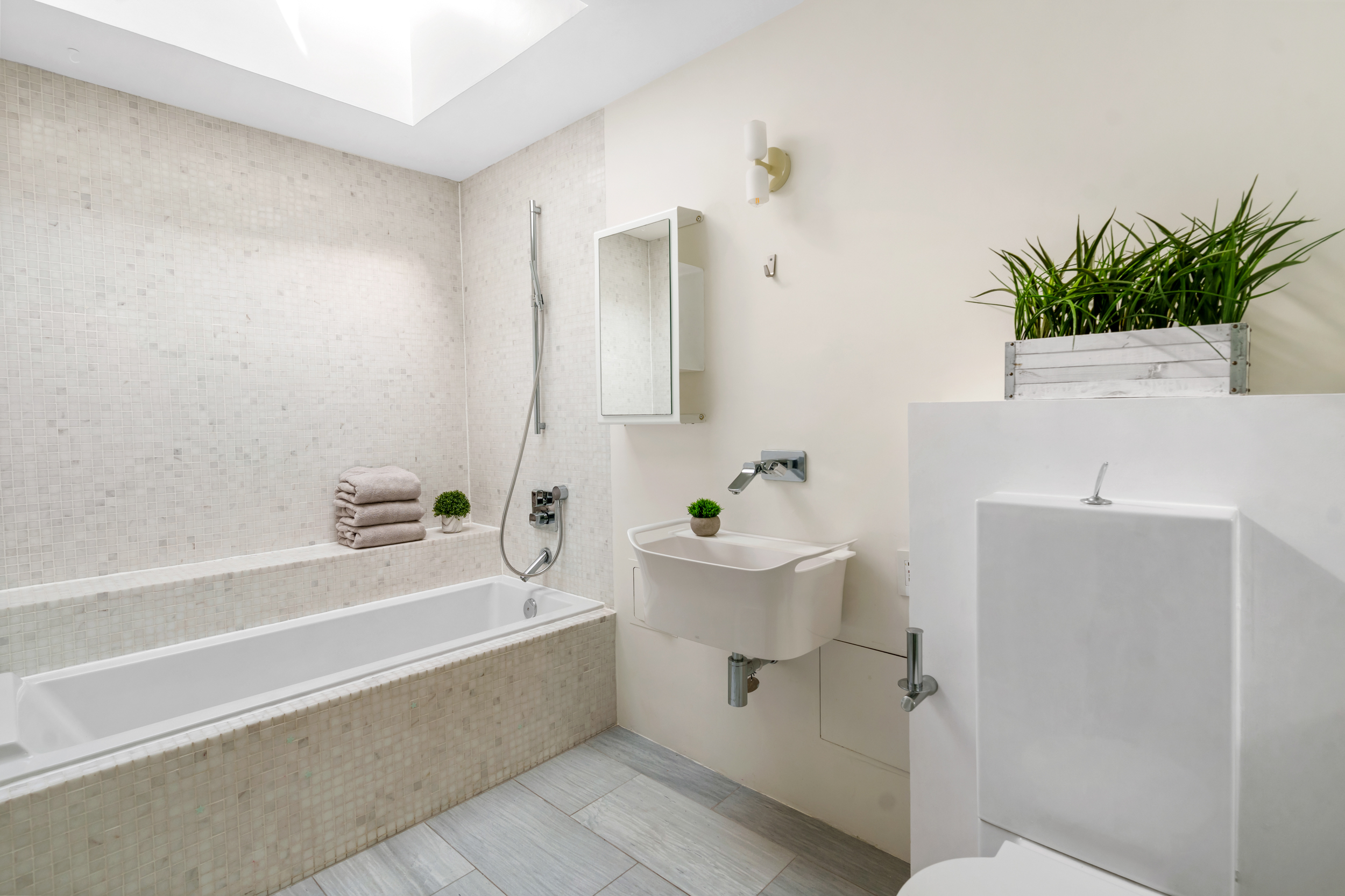 214 East 9th Street, Unit PH4D Manhattan, NY 10003 - Photo 10 of 15 a bathroom with a sink a toilet and bathtub