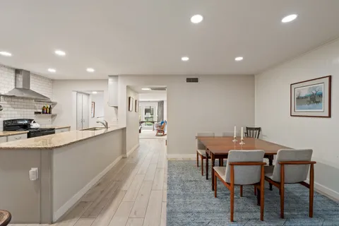 a kitchen with stainless steel appliances granite countertop a sink and a refrigerator
