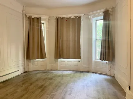 an empty room with windows and closet
