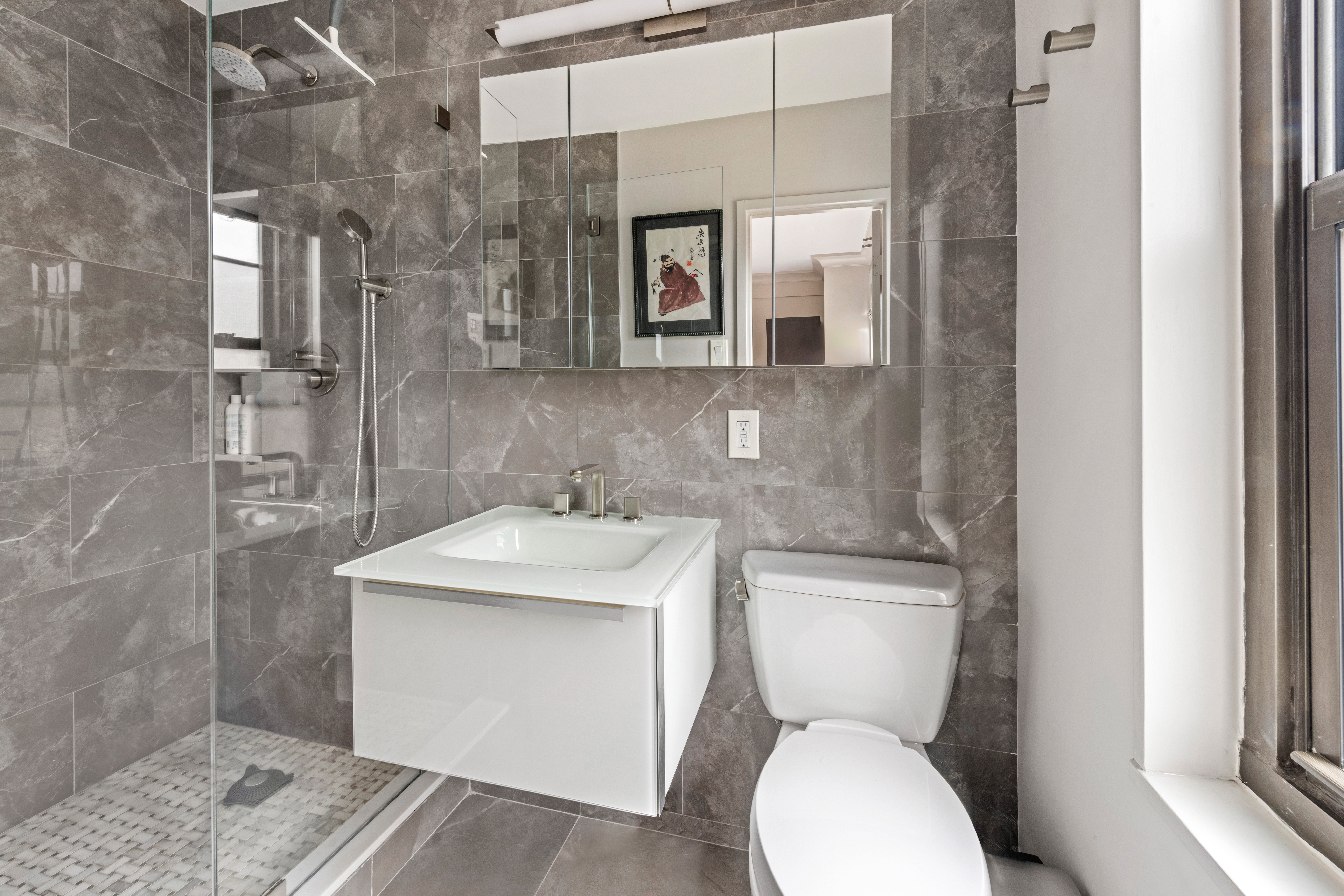 180 West End Avenue, Unit 25M Manhattan, NY 10023 - Photo 6 of 11 a bathroom with a toilet sink and mirror