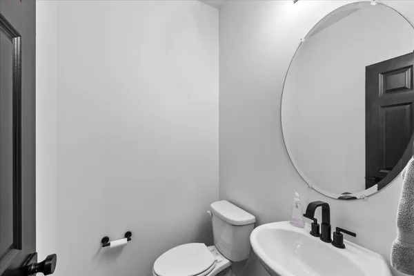 a bathroom with a sink mirror and toilet
