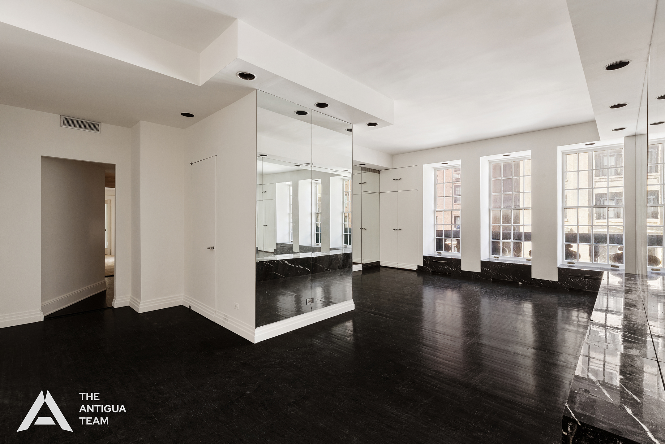 45 East 66th Street, Unit 4W Manhattan, NY 10065 - Photo 4 of 27 a view of a living room hardwood floor and windows