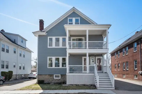 a front view of residential houses with yard