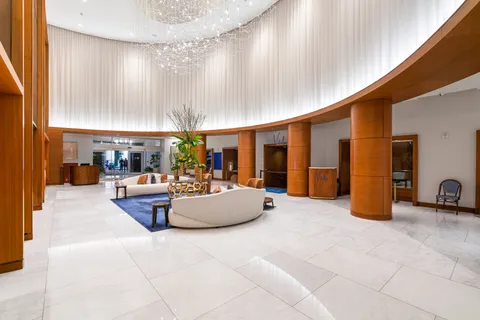 a living room with furniture and a lamp