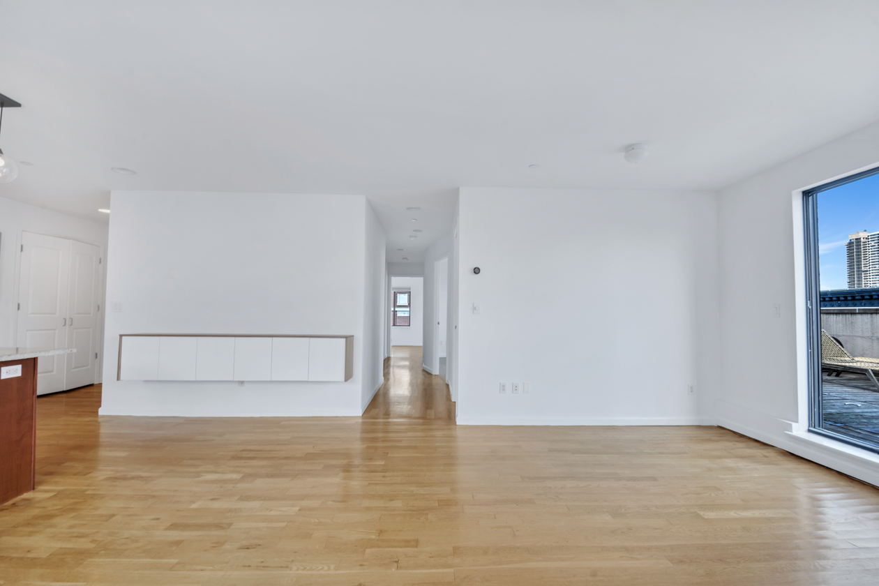 416 East 117th Street, Unit PH6 Manhattan, NY 10035 - Photo 8 of 20 a view of empty room with wooden floor