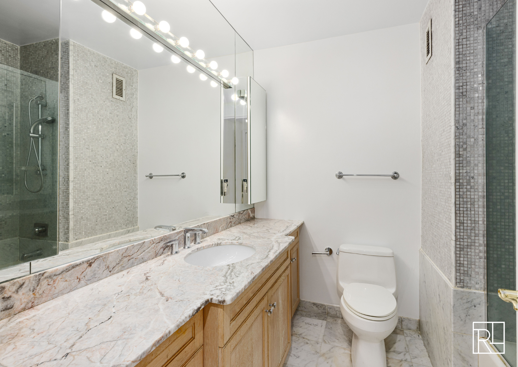 30 West 61st Street, Unit 16D Manhattan, NY 10023 - Photo 8 of 12 a bathroom with a granite countertop sink toilet and shower