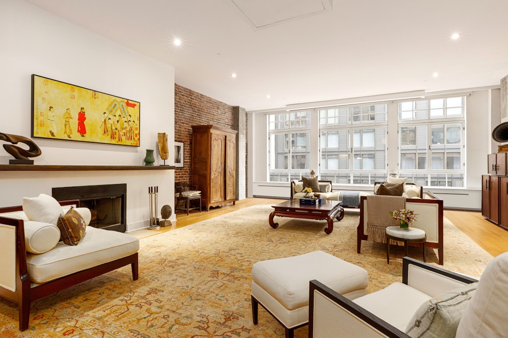 354 Broadway, Unit 4 Manhattan, NY 10013 - Photo 2 of 13 a living room with furniture and a fireplace