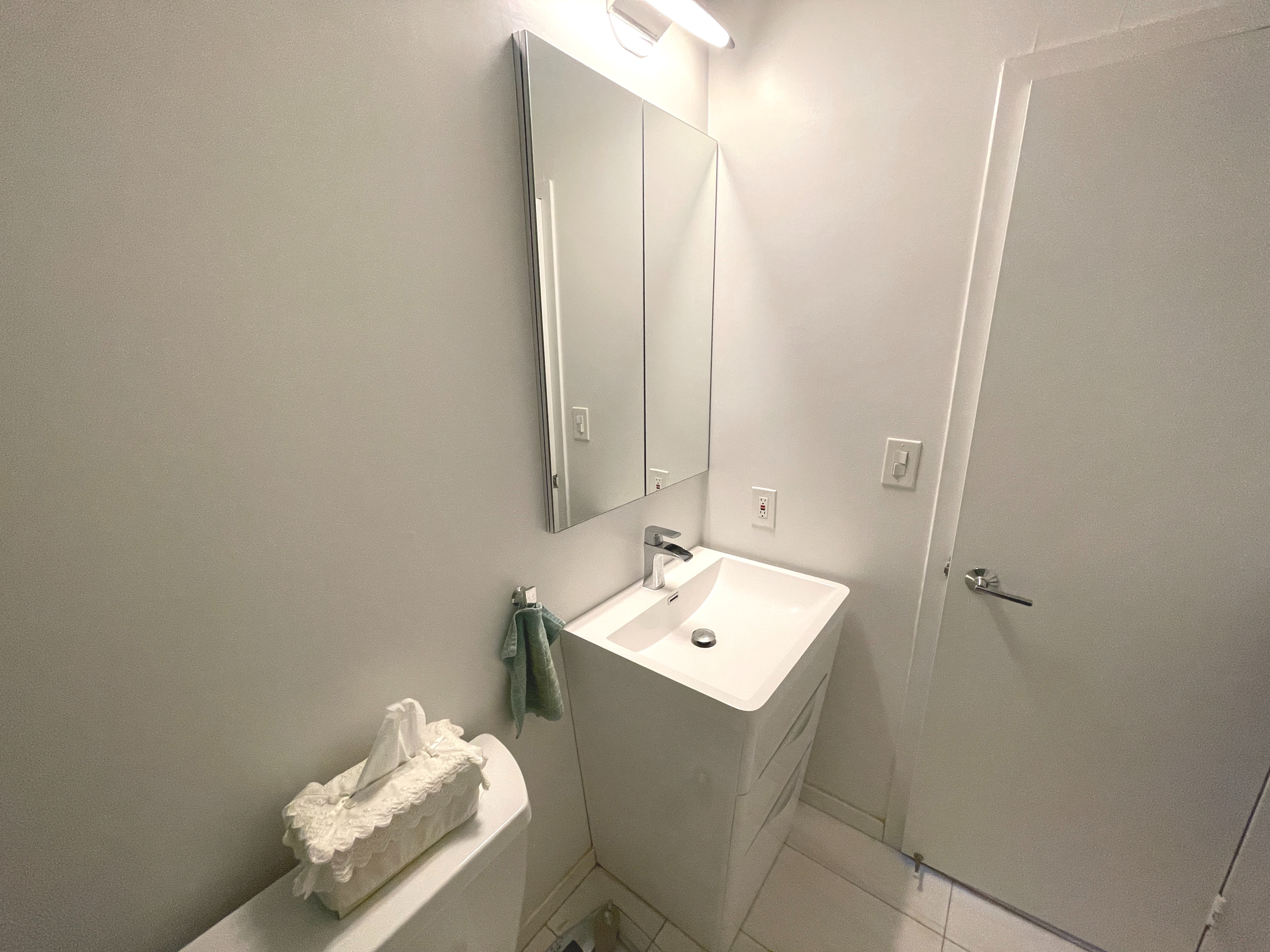 25-40 Shore Boulevard, Unit 15T Queens, NY 11102 - Photo 11 of 24 a bathroom with a sink and a mirror