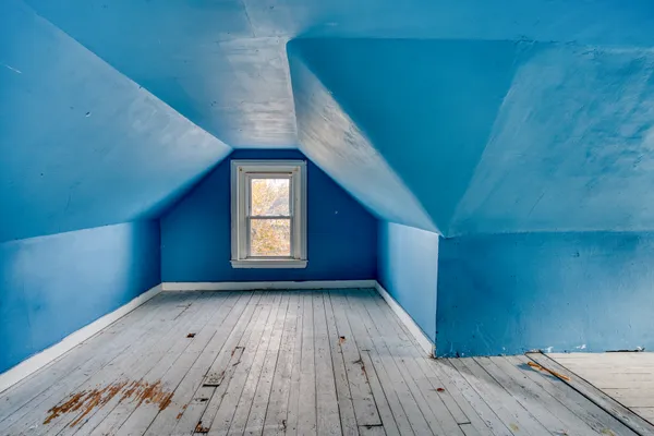 a view of empty room with window and wooden floor