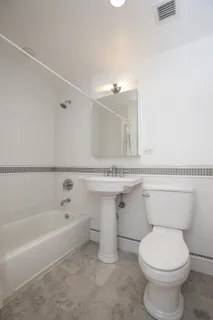 a bathroom with a sink a toilet and bathtub