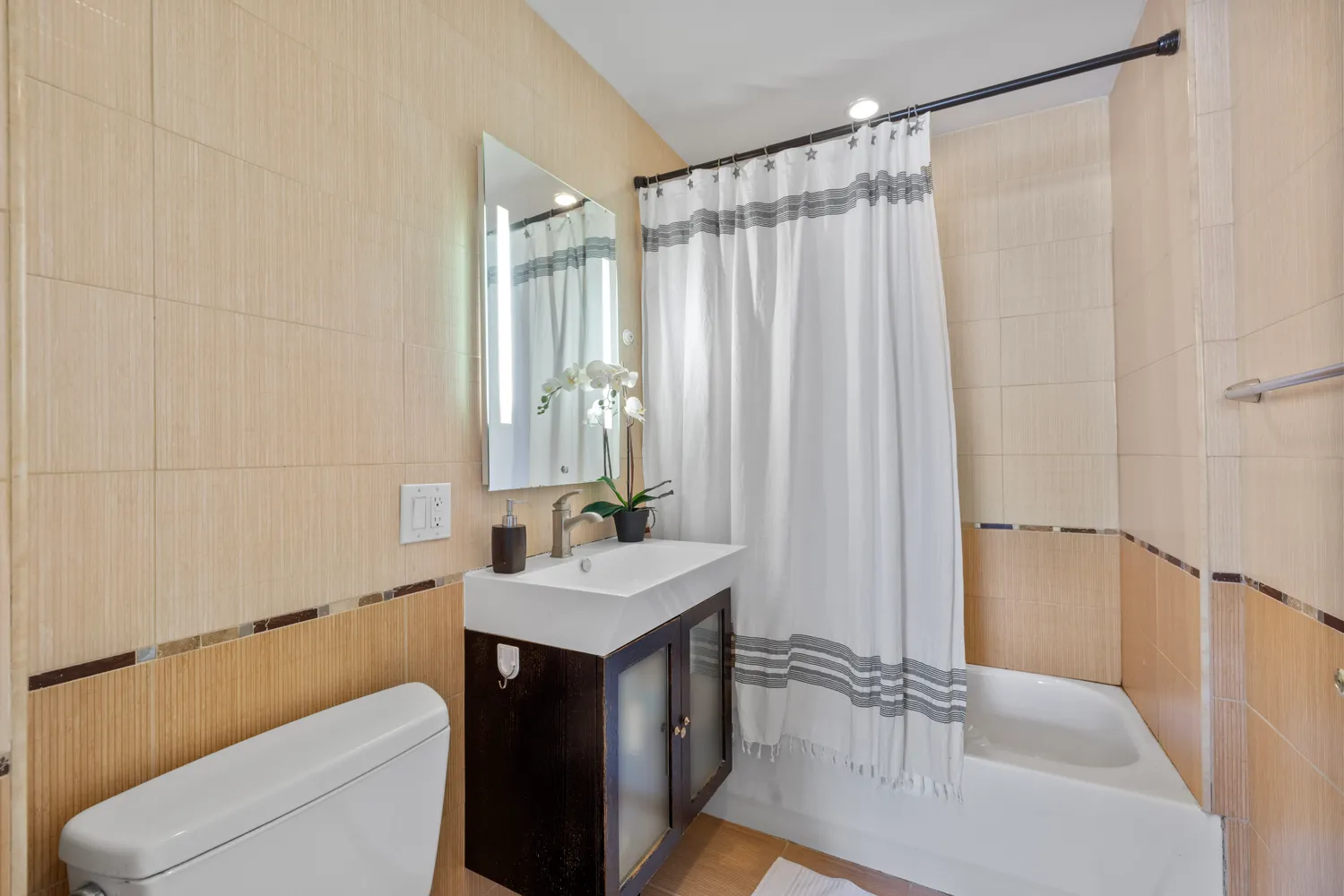 a bathroom with a sink a toilet and shower