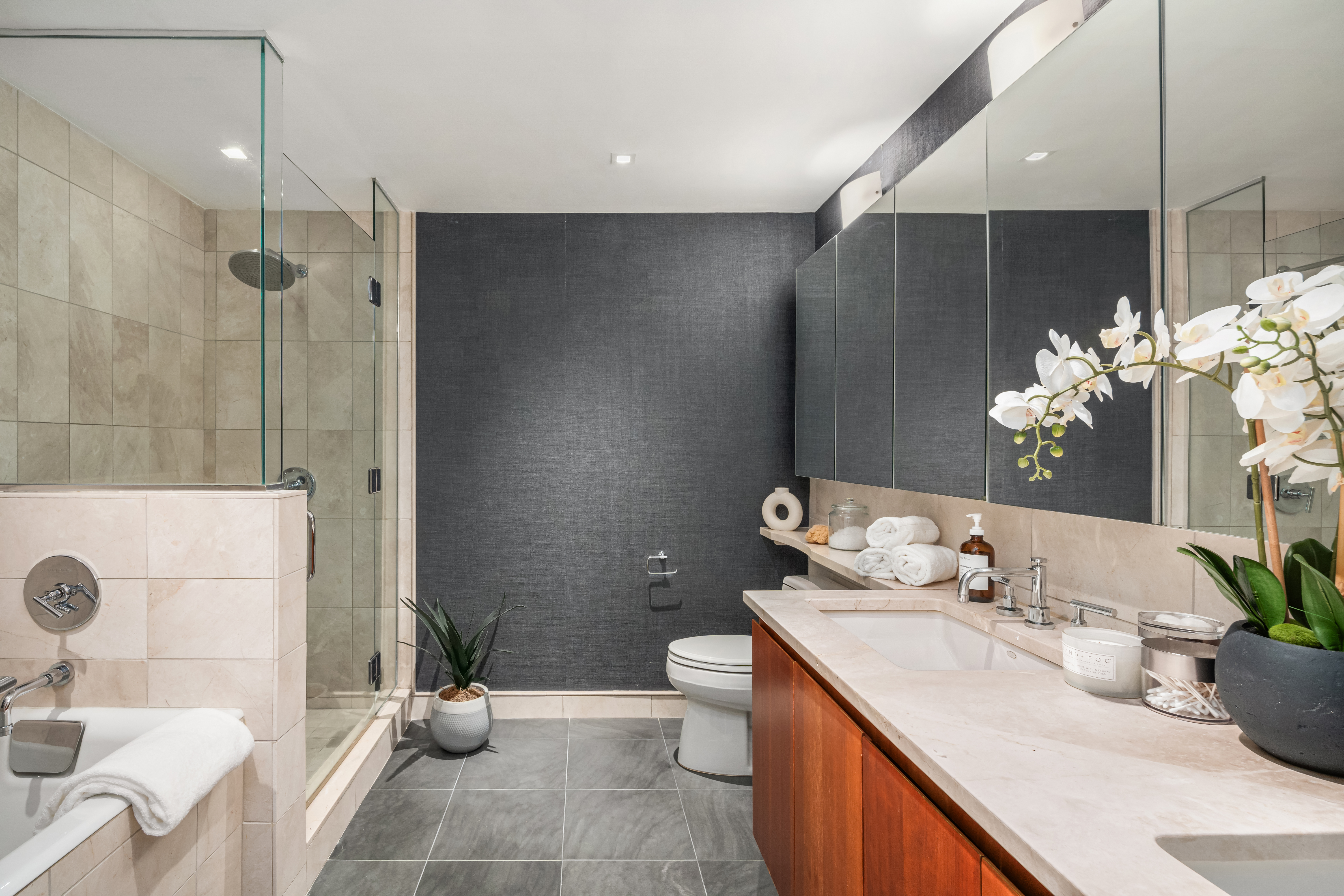 255 Hudson Street, Unit TH1 Manhattan, NY 10013 - Photo 8 of 9 a spacious bathroom with a granite countertop sink a toilet and shower