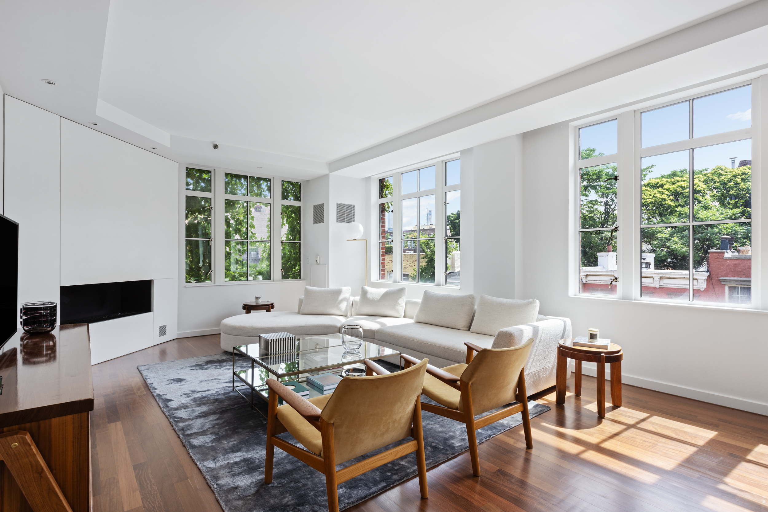 744 Greenwich Street, Unit 4 Manhattan, NY 10014 - Photo 6 of 34 a living room with furniture a flat screen tv and a large window