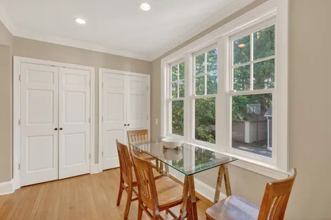 a view of a livingroom and dining room with furniture window and outside view