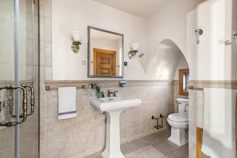 a bathroom with a sink toilet and shower