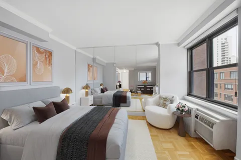 a bedroom with bed and a large window