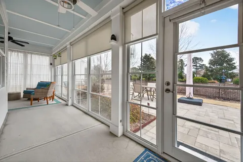 a living room with furniture and a floor to ceiling window
