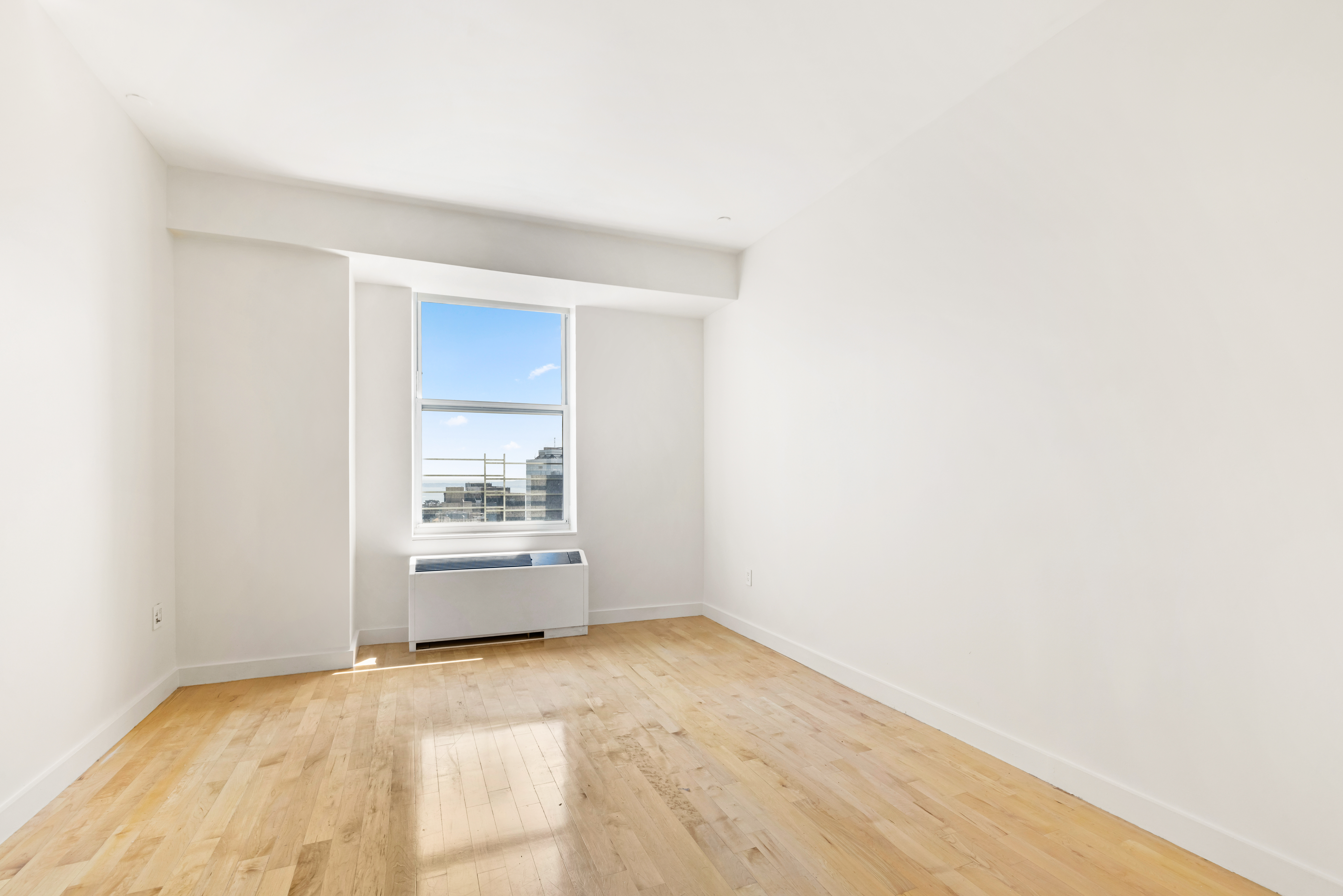 15 Broad Street, Unit 3930 Manhattan, NY 10005 - Photo 17 of 21 a view of empty room with a kitchen