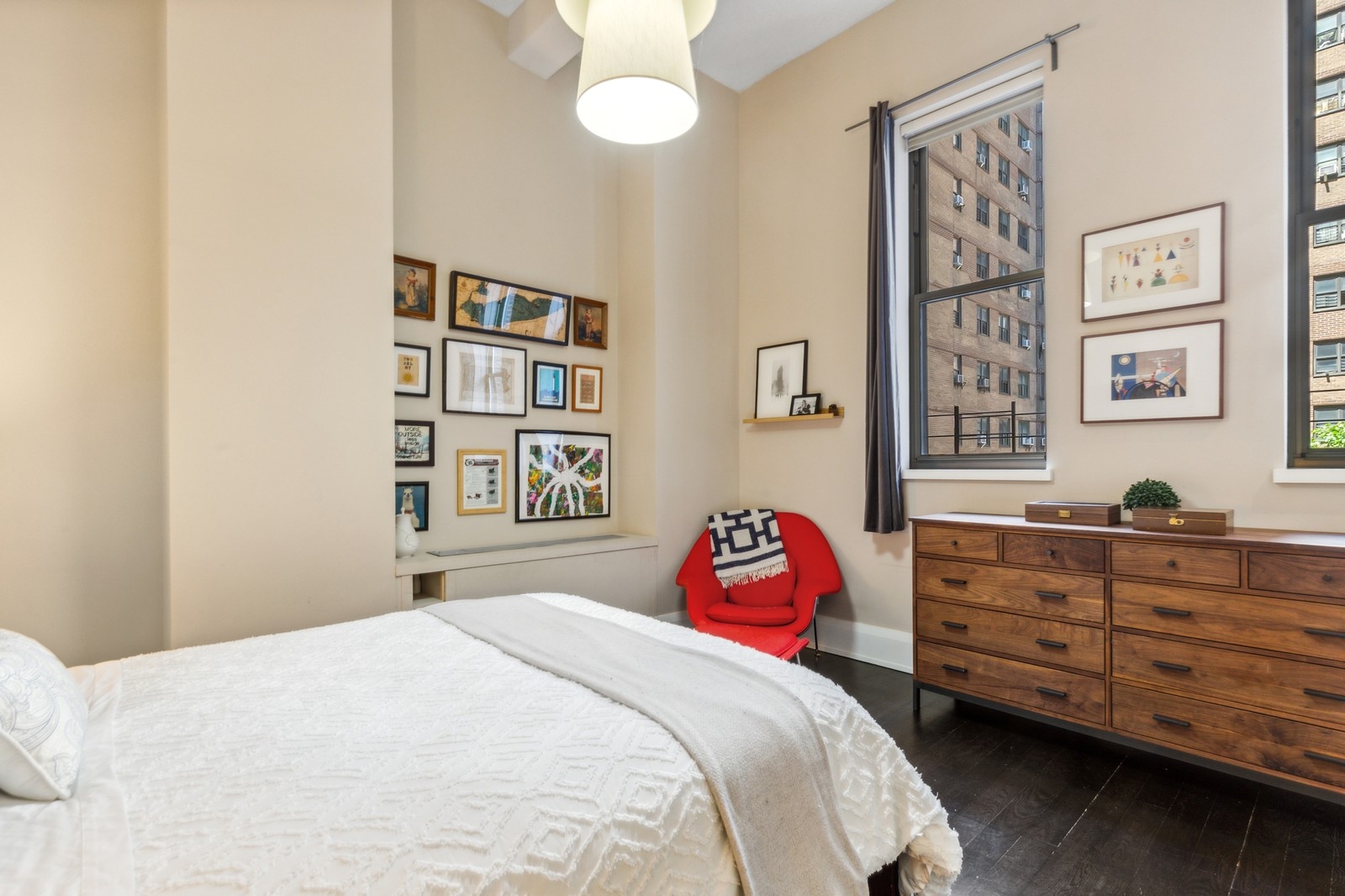 263 9th Avenue, Unit 3D Manhattan, NY 10001 - Photo 6 of 15 a bedroom with a bed and a dresser in it