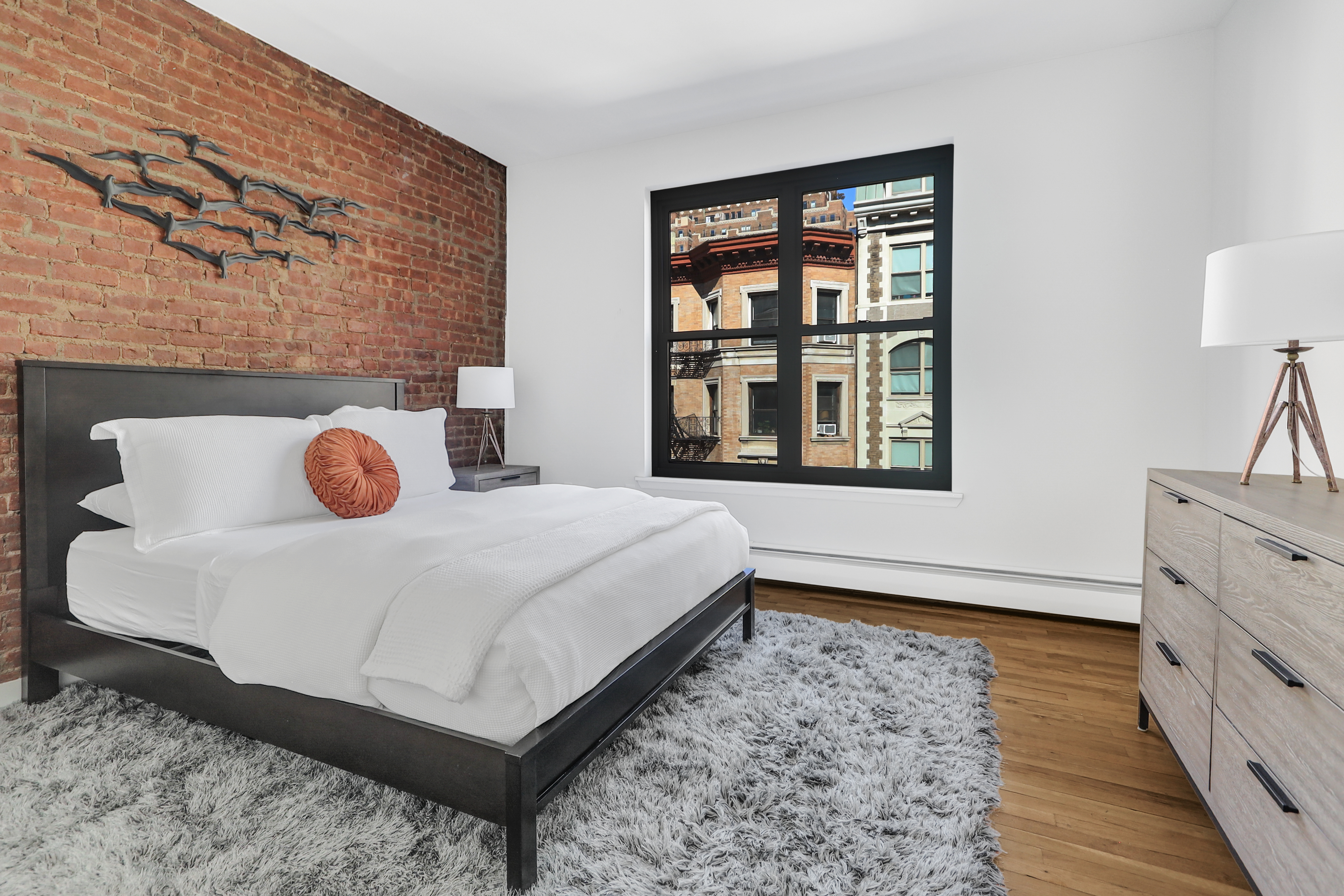 314 West 94th Street, Unit 5D Manhattan, NY 10025 - Photo 7 of 13 a bedroom with a bed and a window