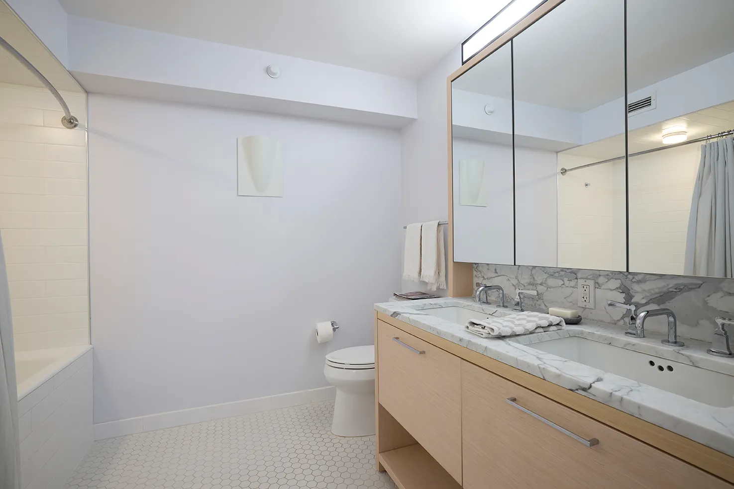 a bathroom with a granite countertop sink a toilet and a shower