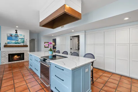 a large kitchen with stainless steel appliances kitchen island granite countertop a sink and cabinets