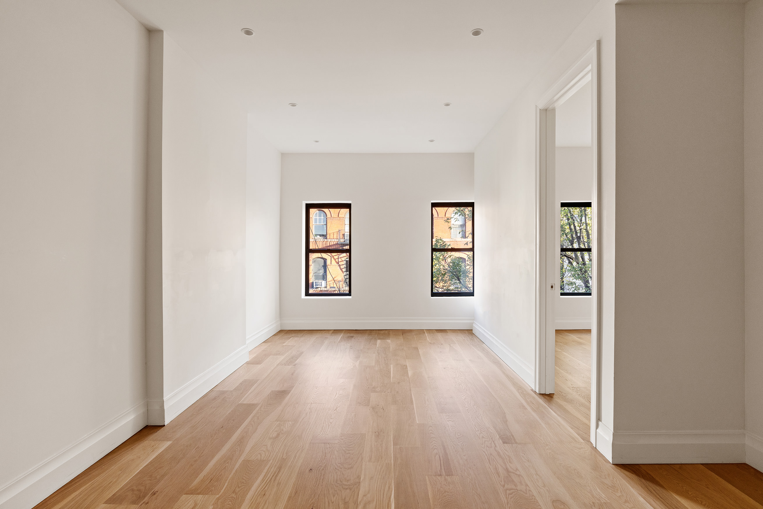 80 7th Avenue, Unit 4 Brooklyn, NY 11217 - Photo 1 of 9 an empty room with wooden floor and windows