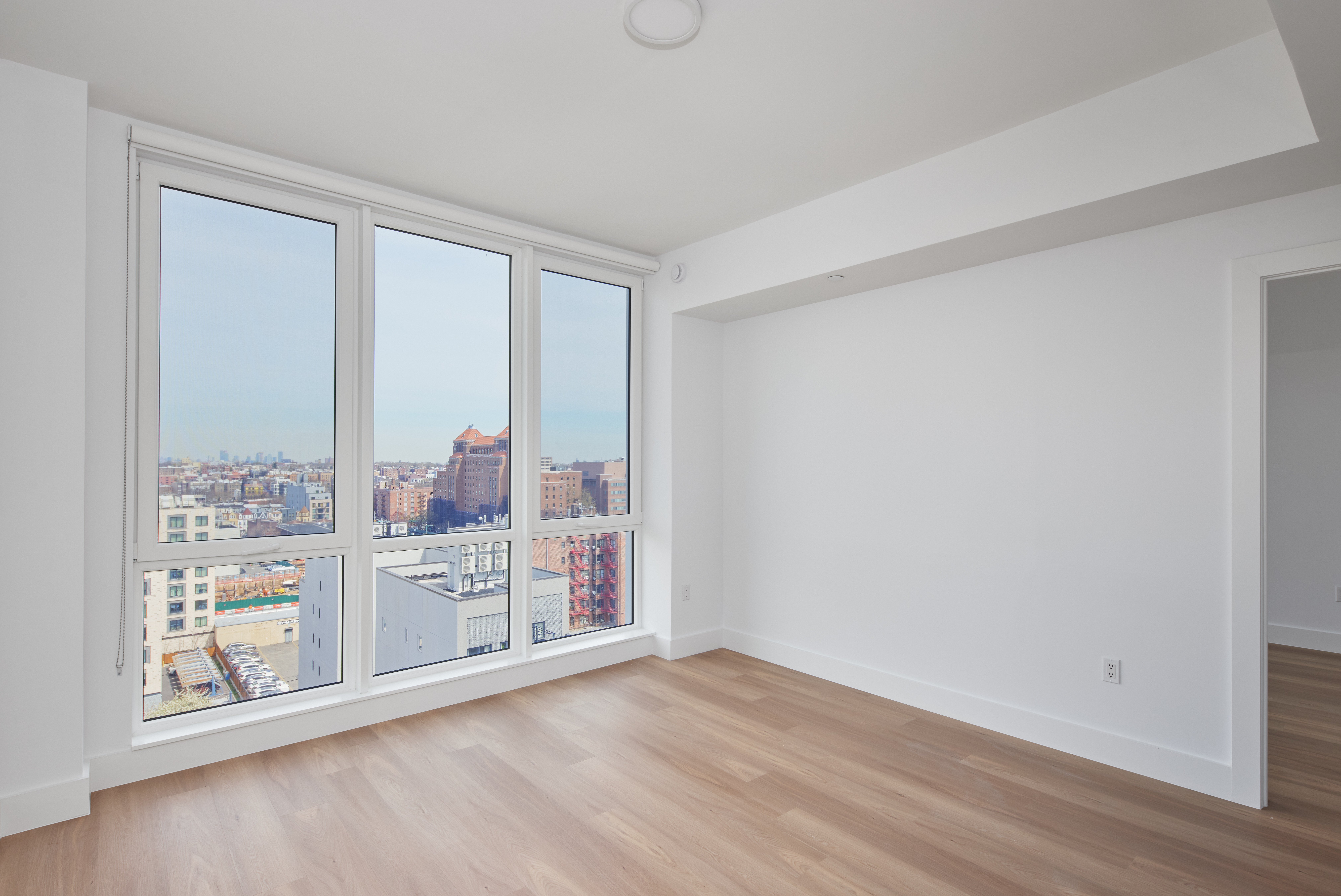 340 Lenox Road, Unit PHB Brooklyn, NY 11226 - Photo 4 of 26 wooden floor in an empty room with a window