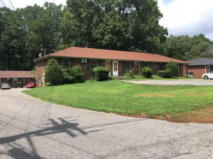 a view of a patio with a table and chairs under an umbrella