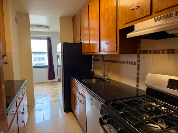 a kitchen with a refrigerator and a stove