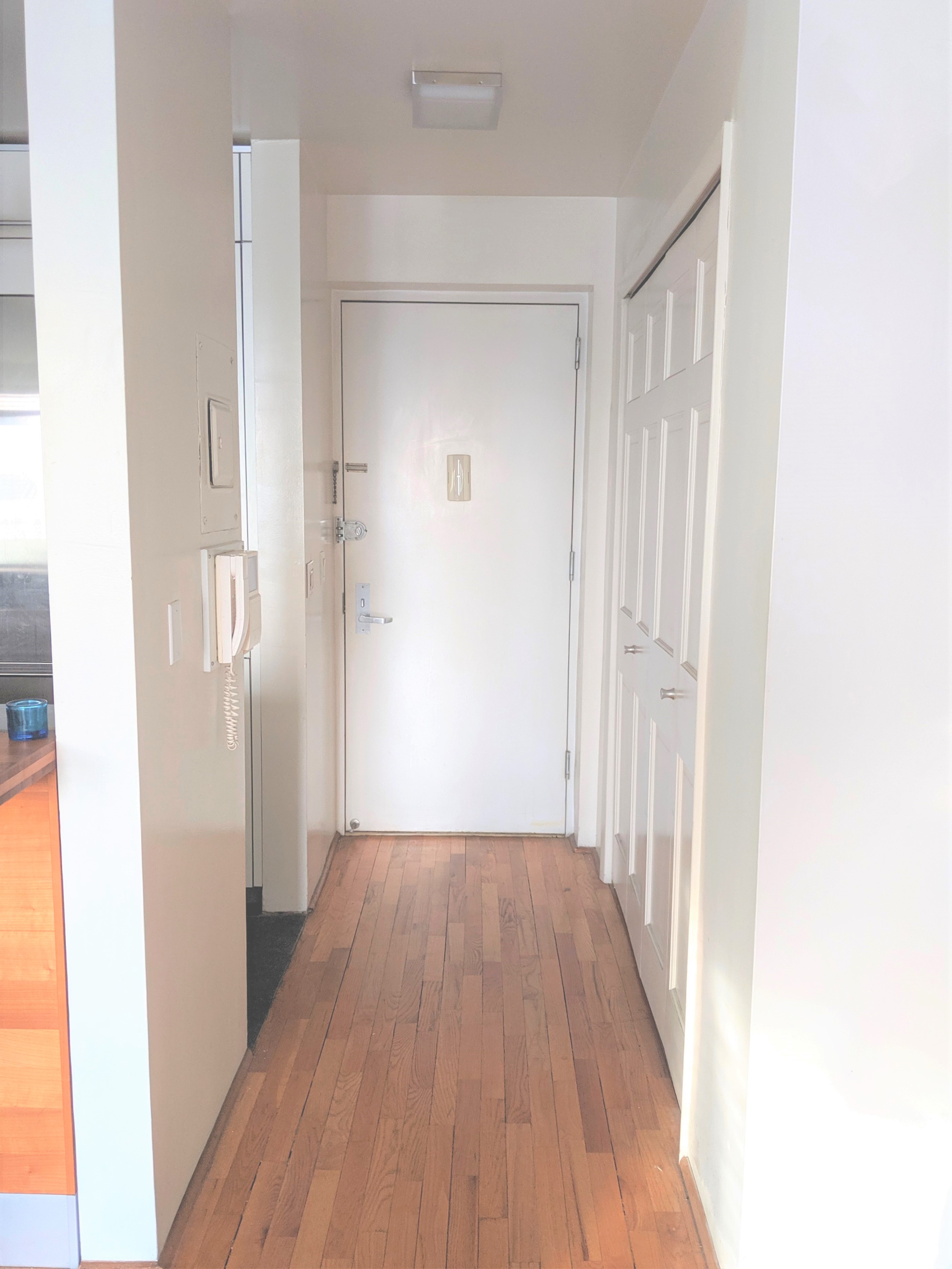 167 Perry Street, Unit 5N Manhattan, NY 10014 - Photo 7 of 12 a view of a hallway with wooden floor