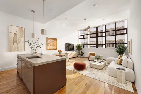 a living room with furniture a rug and a flat screen tv