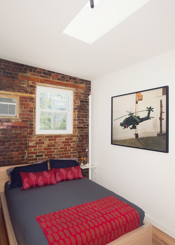 5-46 50th Avenue Queens, NY 11101 - Photo 10 of 17 a view of a bedroom with a bed and wooden floor