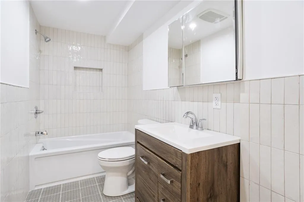 a bathroom with a sink toilet vanity and shower