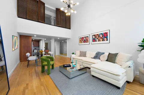 a living room with furniture and a chandelier