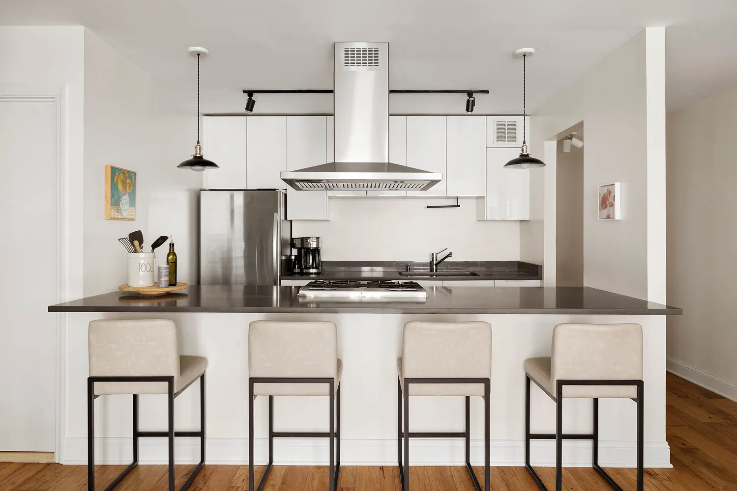 a kitchen with stainless steel appliances kitchen island granite countertop a table and chairs