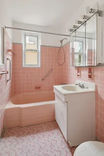 a bathroom with a sink a mirror and a bathtub