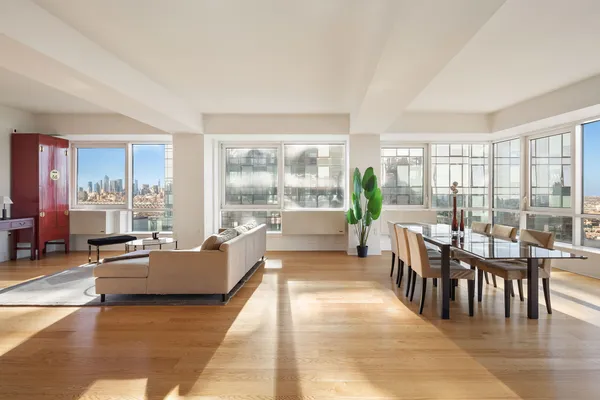 a living room with furniture and large windows