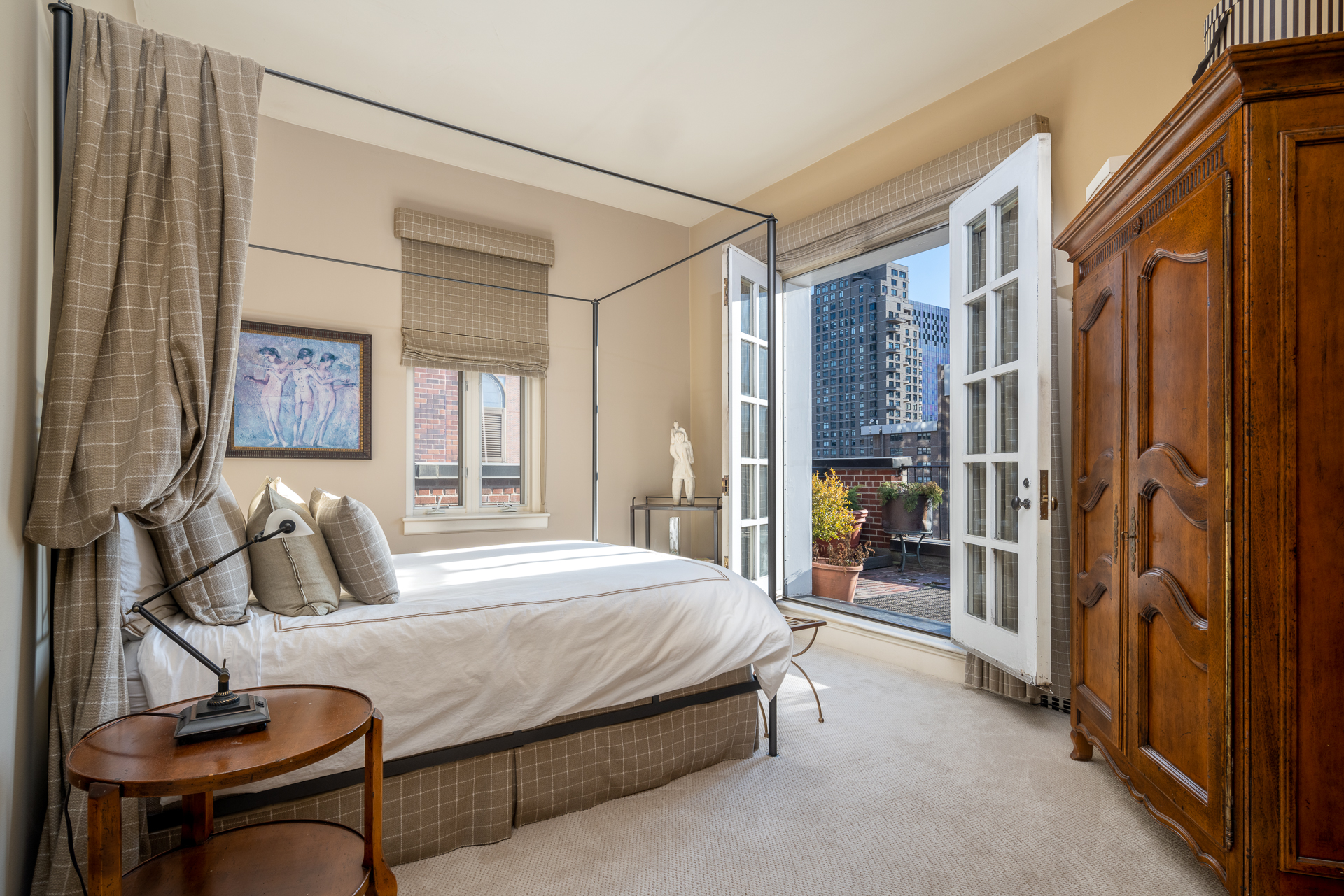 340 East 72nd Street, Unit PH Manhattan, NY 10021 - Photo 8 of 12 a bedroom with a large bed and a chandelier