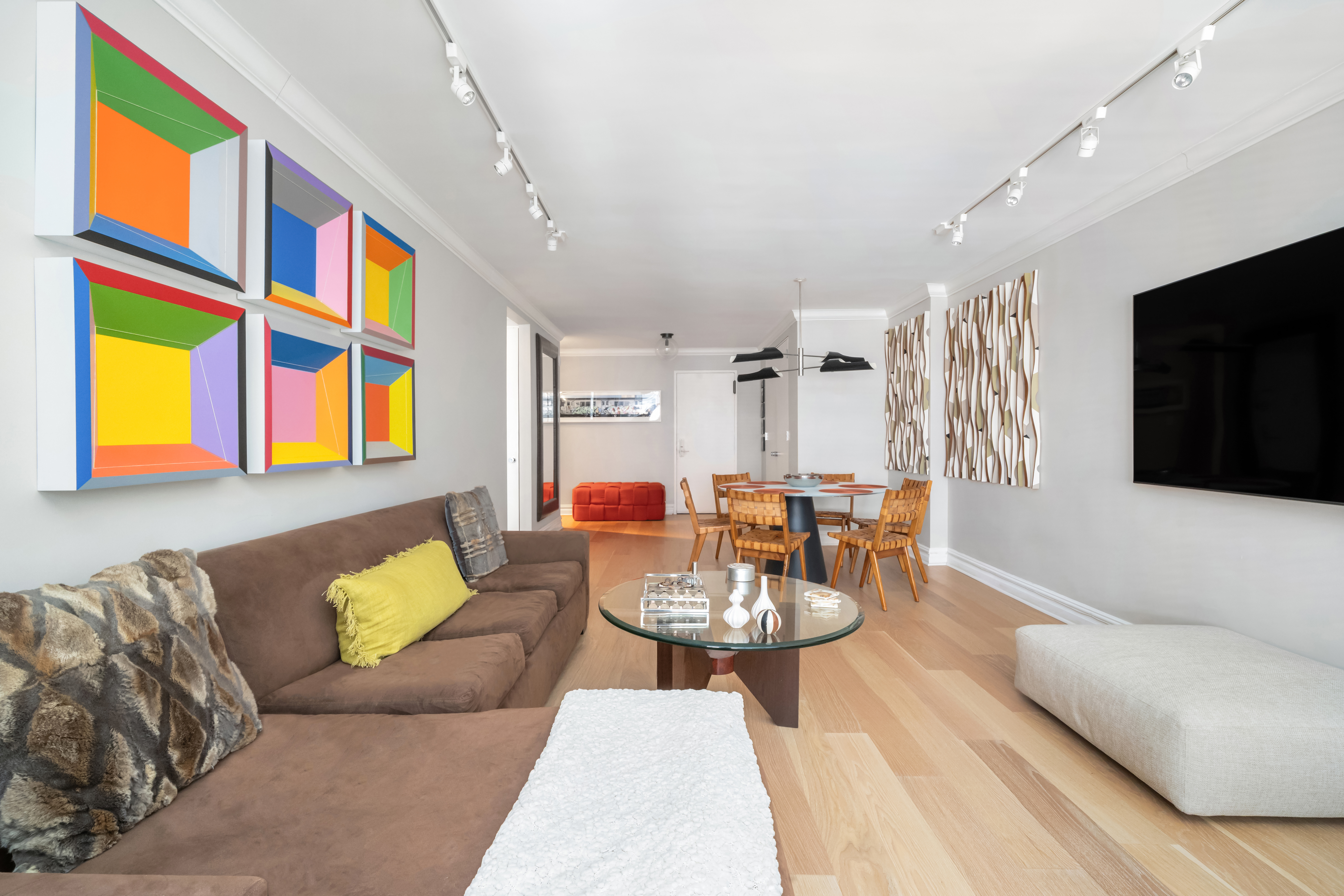 77 West 55th Street, Unit 9F Manhattan, NY 10019 - Photo 4 of 11 a living room with furniture fireplace and a flat screen tv