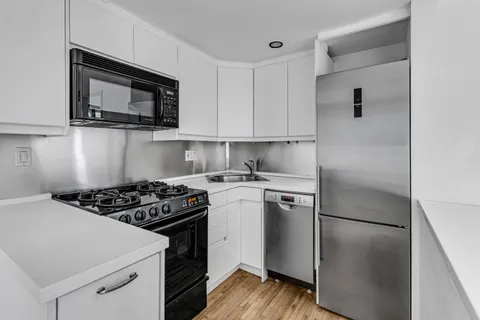 a kitchen with a stove microwave and refrigerator