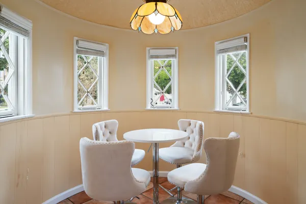 a dining room with furniture and a window
