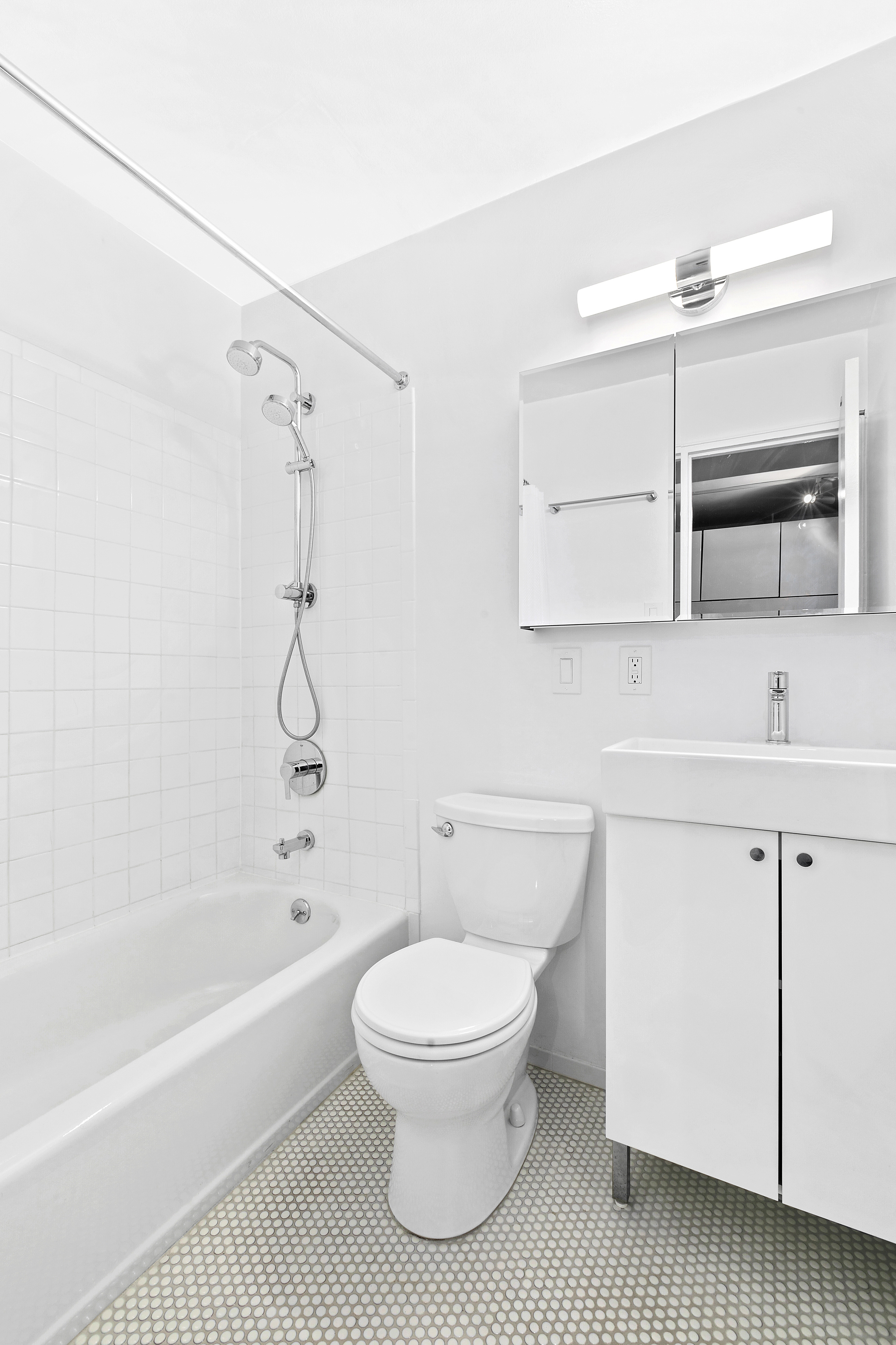 4 Lexington Avenue, Unit 8F Manhattan, NY 10010 - Photo 5 of 7 a bathroom with a toilet a sink and bathtub